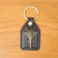 Lifestyle image of aircraft design keychain next to keys and accessories