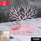 Side view of large pink deer jewelry stand with tree-shaped branches, India