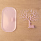 Pink deer jewelry stand with earrings displayed, India