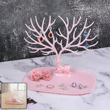 Pink deer-shaped jewelry stand with tree branches for earrings and rings, India