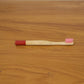 Lifestyle image of bamboo toothbrush in bathroom setting