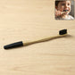 Natural bamboo toothbrush featuring soft charcoal-infused bristles