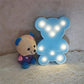 Cute teddy bear shaped LED night light with warm ambient lighting for children’s rooms