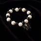 Close-up of black and white beads and cross pendant on bracelet