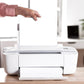 Stack of A4 copier paper next to a laser printer for office use