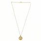 detailed close-up of golden pendant showing fine intricate patterns