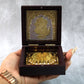 Video presenting golden Charan Paduka in wooden box used as devotional pooja accessory