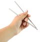 A pair of polished stainless steel chopsticks isolated on a white background.