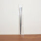 Stainless steel chopsticks actively used to pick up food during a meal.