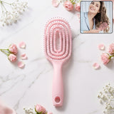 Pink curved vented detangling hair brush designed for effortless hairstyling