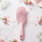 Side view showing ergonomic design of curved detangling hair brush