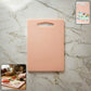 Plastic chopping board with handle grip on kitchen counter
