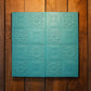 Stack of cyan colored 3D foam wallpaper tiles