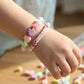 Kids beads DIY set showing colorful plastic beads and string for bracelet and necklace crafting