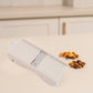 Dry fruit slicer showing slicing action on cashews and ginger