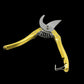 Detailed shot of the sharp gardening secateurs making a clean cut on a small branch.