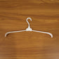 Plastic foldable garment hanger in use for organized closet