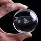 Decorative astronomy crystal ball lamp displayed on a modern desk.