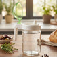 Kitchen oil dispenser bottle with green lid for controlled pouring