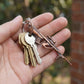 Top view of durable metal gun keychain with antique finish