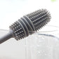 Hand holding a bottle cleaning brush, demonstrating its comfortable grip.