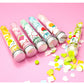 Assorted colorful flower soap strips displayed inside clear test tube