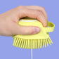 Top view of the easy-press button for the shampoo dispenser on the silicone bath brush.