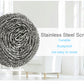 Round stainless steel scrubber shown in use, effortlessly removing tough stains from cookware.
