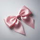 Satin hair bow clip showing smooth fabric and bow design for hair styling