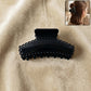 Elegant black hair claw clip holding hair securely during styling