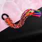 Hair extension showing elastic attachment and multicolor braided design