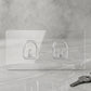 Close-up of adhesive backing on transparent wall hook