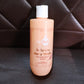 Hydrating body wash bottle resting on a bathroom surface