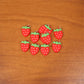 Colorful set of strawberry-themed keychain accessories
