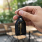 Back view of leather and metal sword emblem keychain
