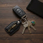 Side angle showing metal sword emblem on leather keychain
