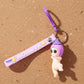 Detailed shot of baby doll keychain showing silicone texture