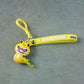Keychain with cartoon dinosaur figure secured by metal clip hook