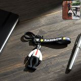 Cartoon man keychain with vibrant rainbow strap attached to keys