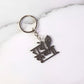 Key pendant attached to Radhe Krishna metal keychain highlighting craftsmanship