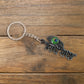 Detailed craftsmanship on Radha Krishna Radhe Radhe metal keychain