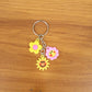 Flower cartoon keychain adding cheerful design to a backpack