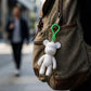 Bear shaped decorative keychain hooked on a backpack zipper