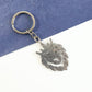 Close-up detail of a stainless steel lion head keychain showcasing the crown