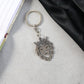 Crowned lion head keychain held in hand showing size and elegant design