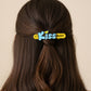Lifestyle image of Kiss text hair clips styled in hair