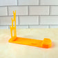 Top-down view of the plastic kitchen knife stand, highlighting the multiple slots for different knives.