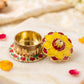 Traditional gold-finished kumkum box in religious ceremonies