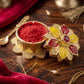 Close-up of ornate golden pooja kumkum box