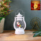 Mini Santa LED lantern glowing with warm light on a wooden surface.